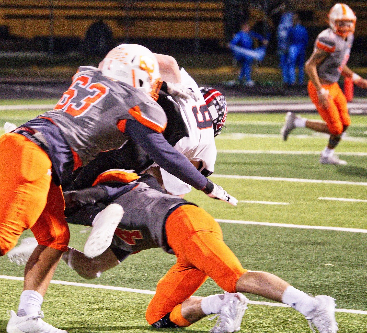 Cole Thompson (63) and Coy Anderson upend the Trojan ballcarrier. [view more from Forney]